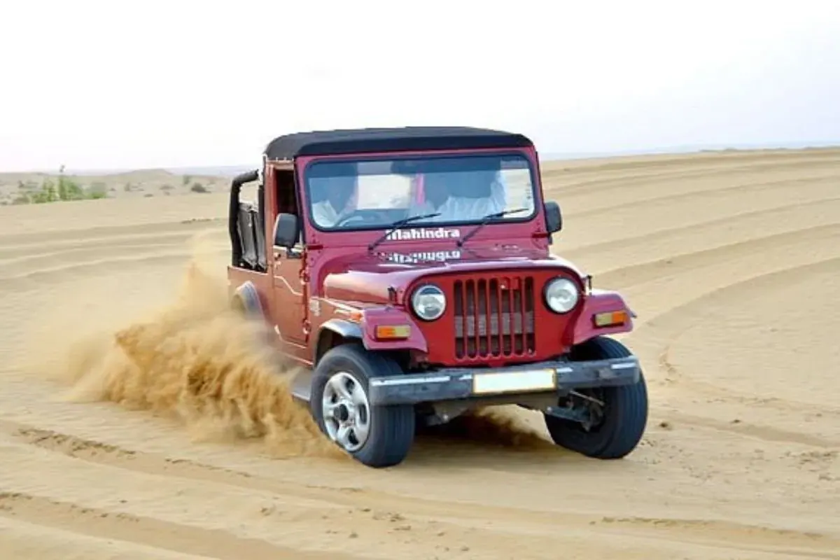 Red jeep on a dune safari in the Thar Desert